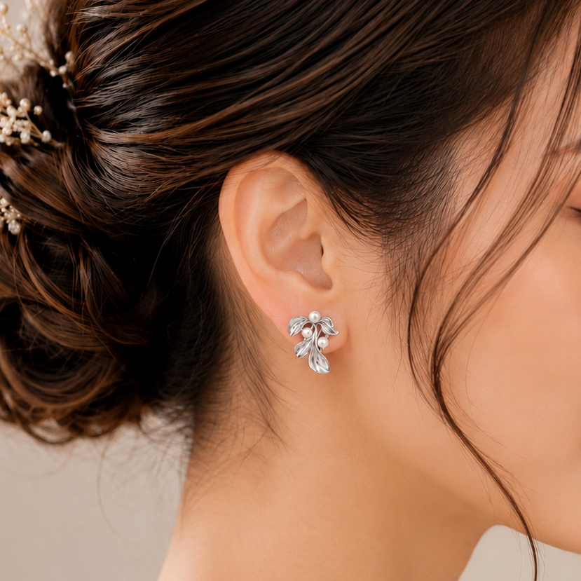 Close-up of a woman wearing elegant earrings with a neutral background
